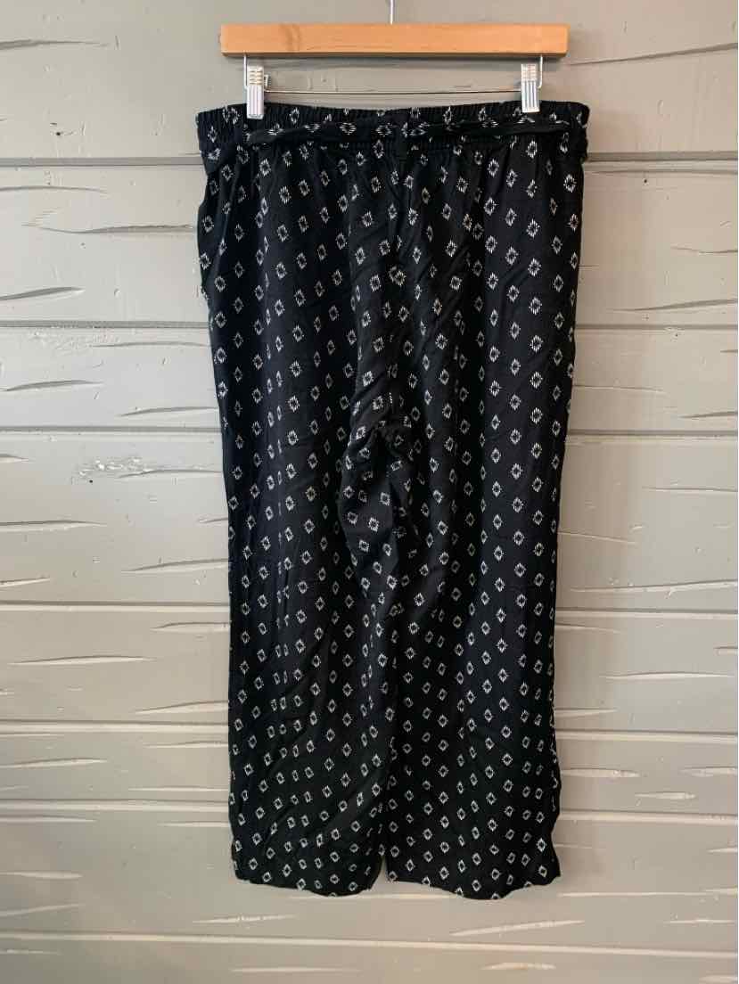 Black wide-leg pants with small white geometric pattern and elastic waistband.