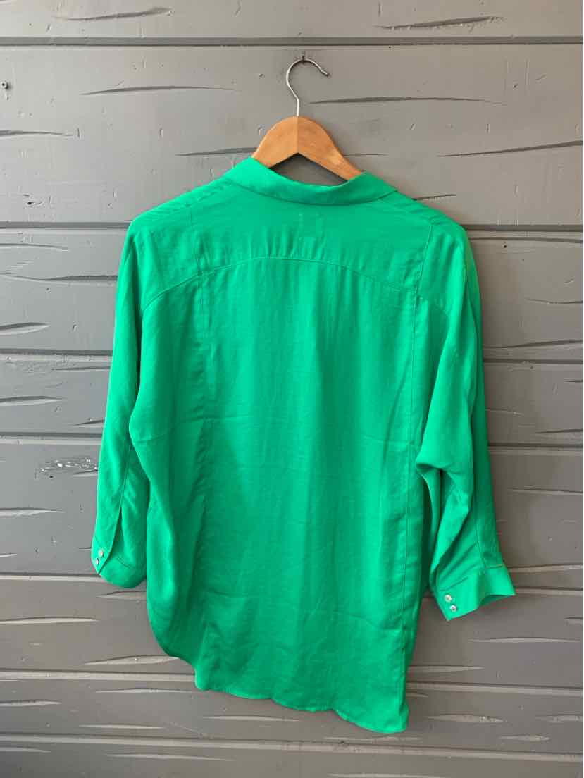 Bright green long-sleeve blouse with a classic collar and buttoned cuffs on a wooden hanger.