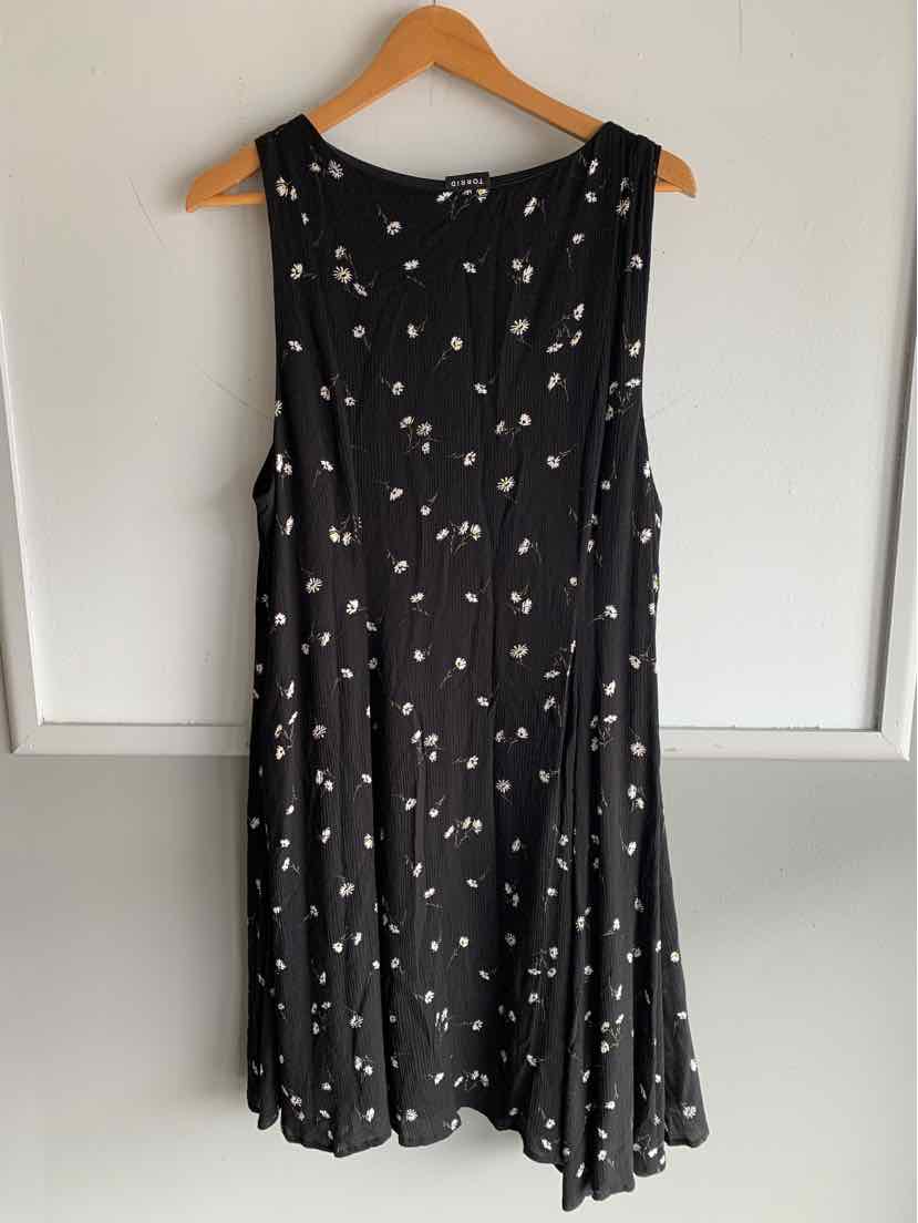 Black sleeveless dress with small white floral print, flowing A-line silhouette, size 1X.