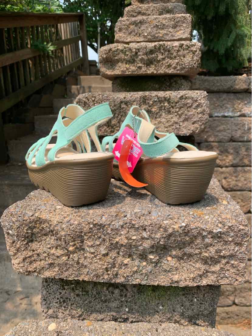 Teal wedge sandals with adjustable back straps and textured rubber soles.