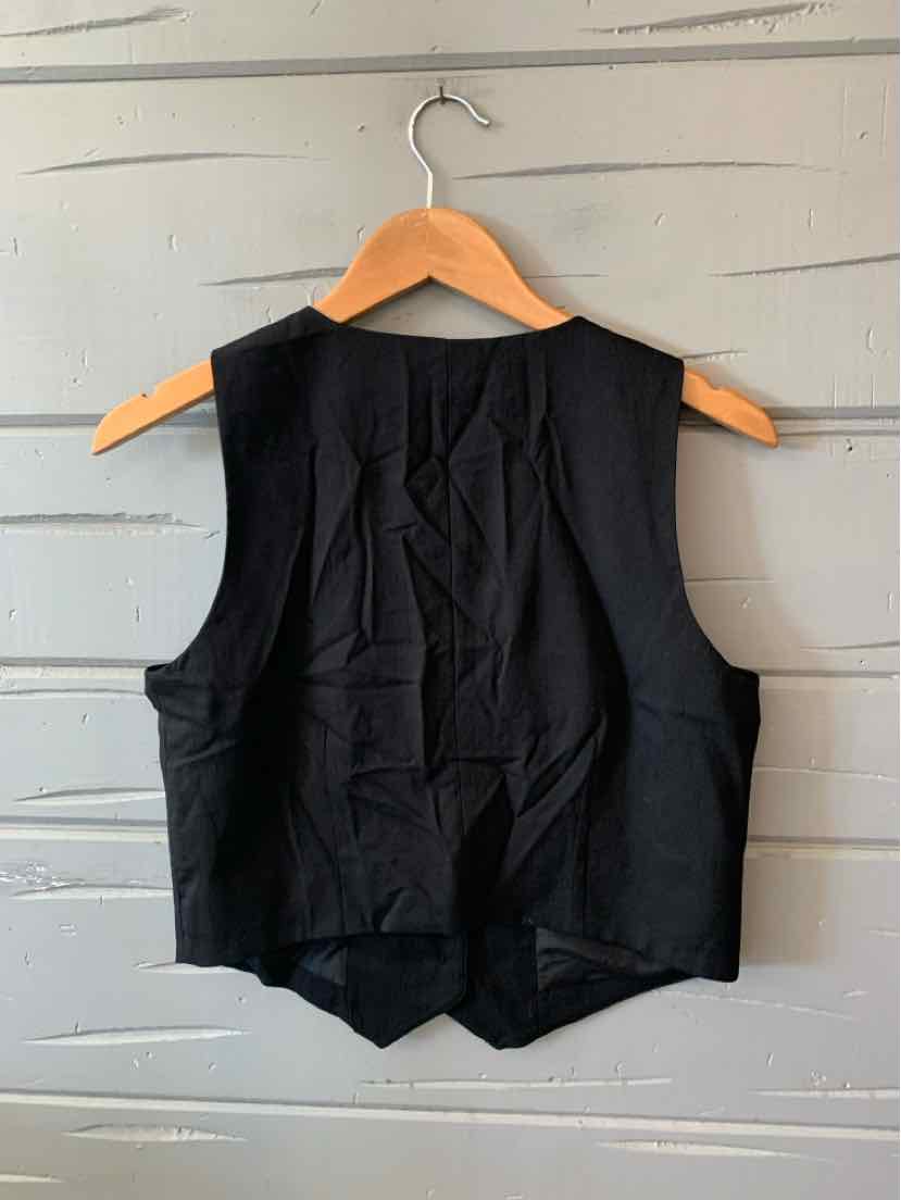 Black sleeveless vest with a V-back design, lightweight fabric, and a tailored fit hanging on a wooden hanger.