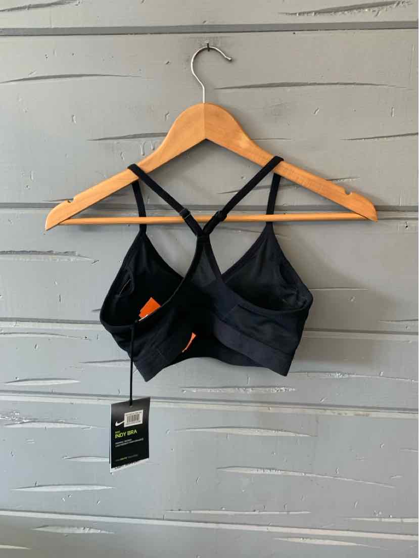 Black Nike sports bra with double crisscross back straps and removable orange padding.