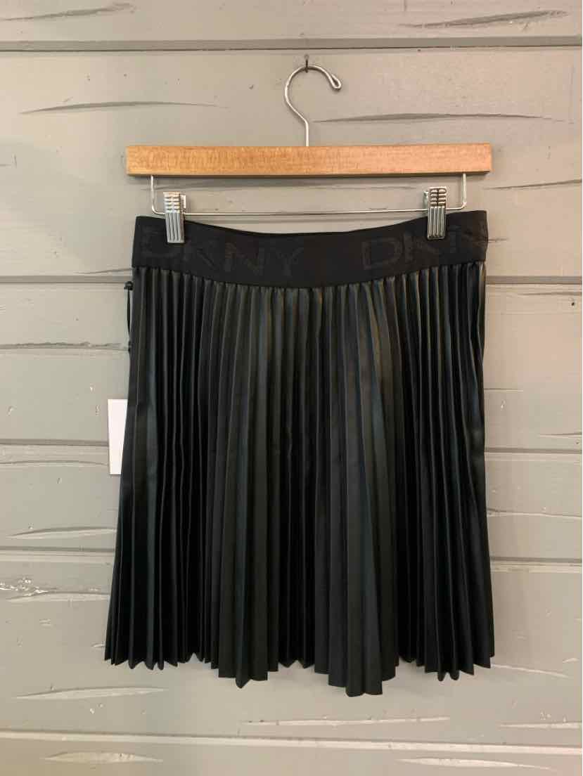 Black pleated mini skirt with elastic waistband, lightweight fabric, hanging on wooden hanger.