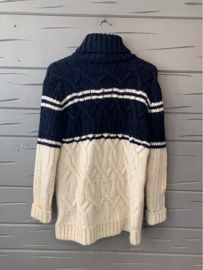 Navy and cream cable-knit sweater with a chunky ribbed turtleneck and horizontal stripe detail.
