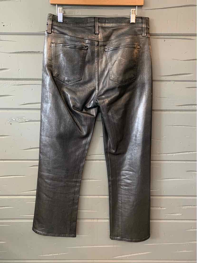 Gray leather pants with back pockets and straight leg cut hanging on wooden hanger.