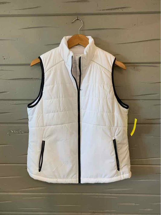 White quilted sleeveless vest with black zipper and trim, standing collar, and two front zip pockets.