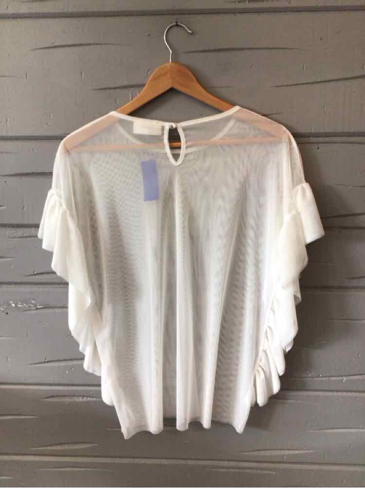 White lace top with flutter sleeves and keyhole back hanging on wooden hanger.