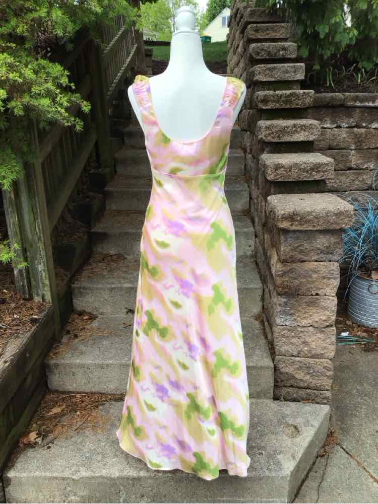 Sleeveless midi dress with watercolor floral print in pink, yellow, and green on light fabric.