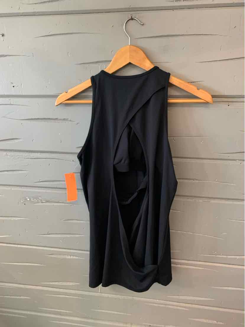 Black sleeveless athletic tank with open back design on wooden hanger.