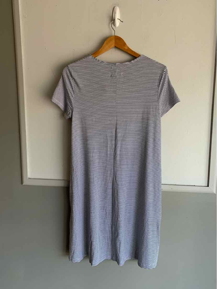 Light gray short-sleeve midi dress with thin white horizontal stripes and a relaxed fit hanging on wooden hanger.