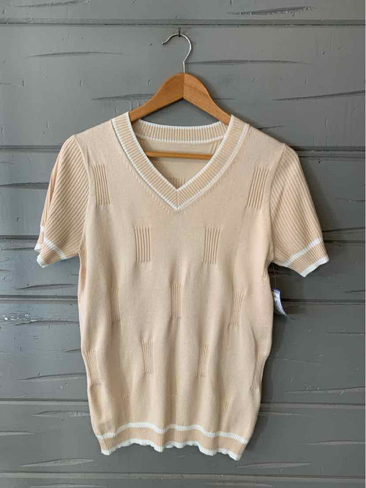 Beige short-sleeve knit sweater with V-neck and white trim on collar, sleeves, and hem.