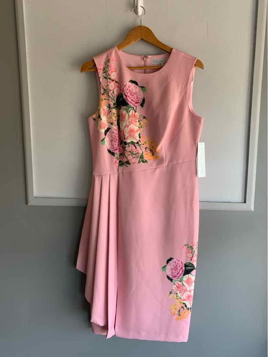 Pink sleeveless dress with floral and flamingo embroidery, pleated skirt detail, knee-length.