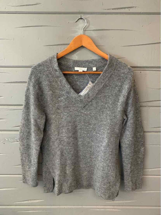 Gray knit women's casual top with V-neck and long sleeves on wooden hanger.