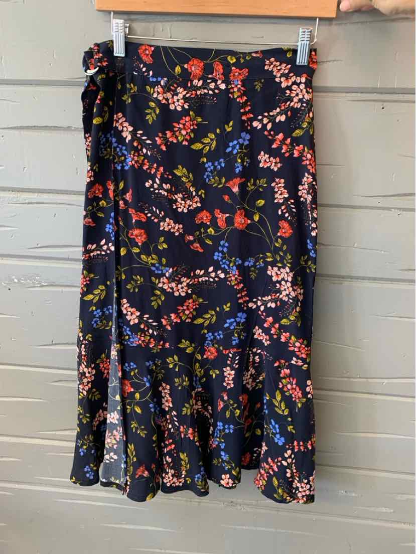 Navy floral midi skirt with red, pink, and yellow flowers and ruffled hem.