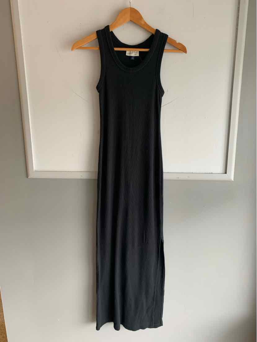 Black sleeveless maxi dress with scoop neckline, slim fit, and soft stretchy fabric.