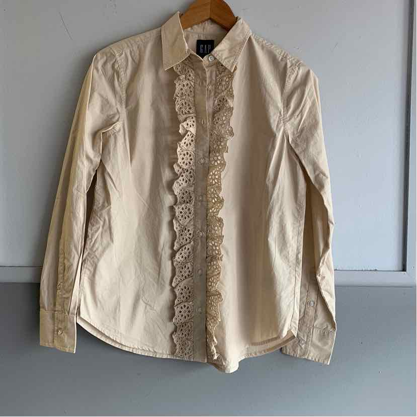 Tan long-sleeve button-up shirt with lace trim along the front placket, collared neckline, and fitted cuffs.
