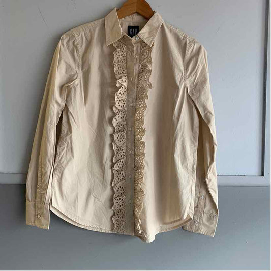 Tan long-sleeve button-up shirt with lace trim along the front placket, collared neckline, and fitted cuffs.