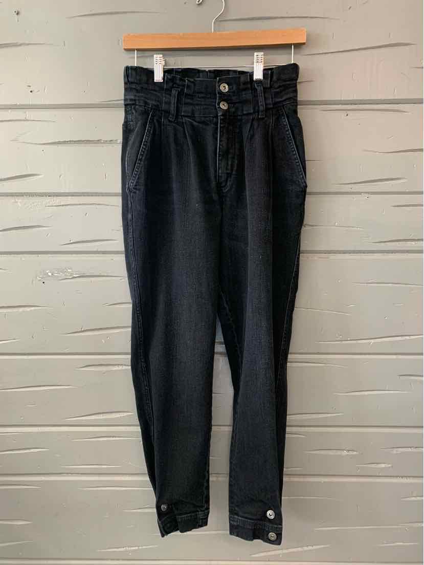High-waisted black denim pants with button fly and ankle strap detailing on size 4 model.