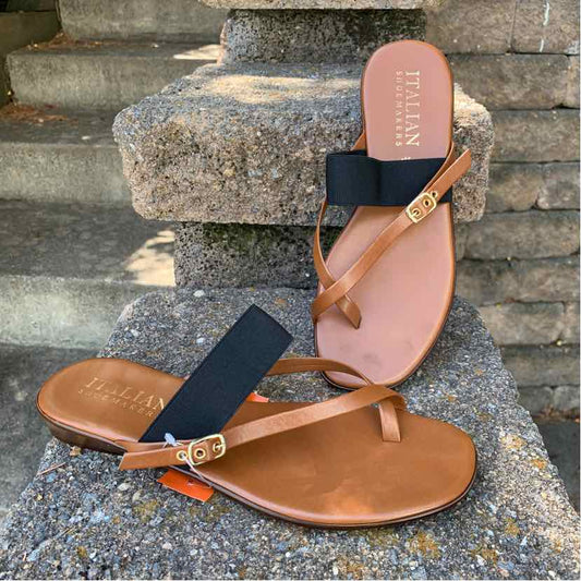 Women's size 9 sandal with tan leather sole, black wide strap, and adjustable tan leather ankle strap with gold buckle.