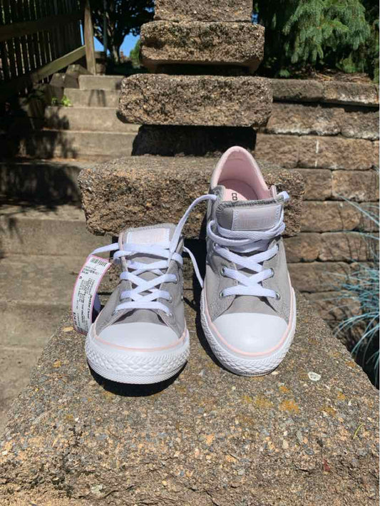 White high-top Converse sneakers with pink inner lining, white laces, and rubber soles.