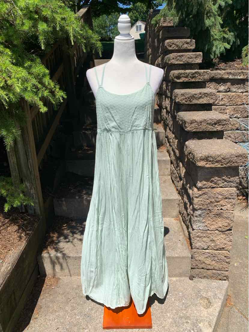 Light mint green sleeveless dress with thin straps and a loose, flowy silhouette.