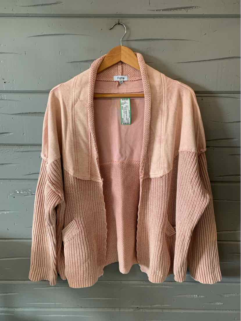 Light pink knit cardigan with open front and ribbed sleeves on wooden hanger.