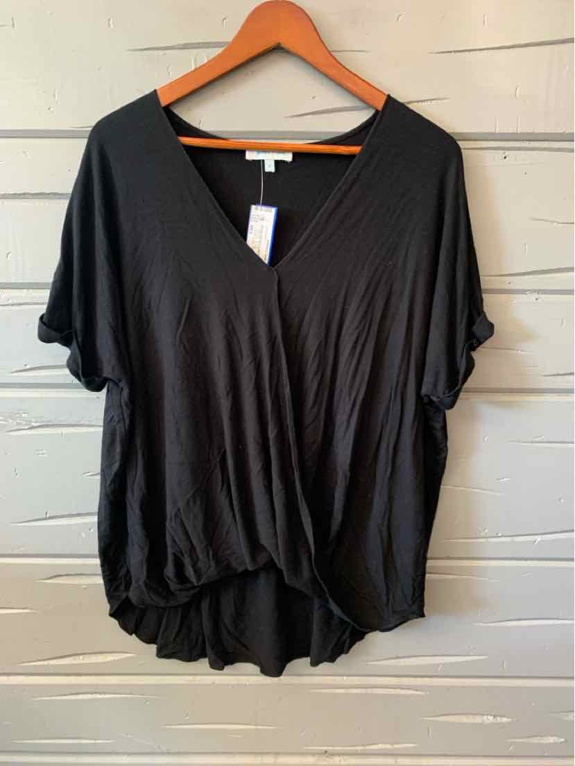 Black loose-fit women's casual top with short sleeves and a V-neck on a wooden hanger.