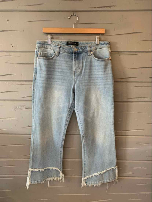 Light blue denim cropped jeans with frayed hems and a slight distressed look, size 10.