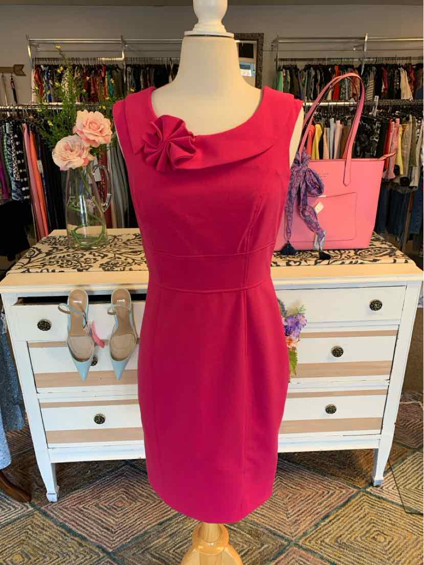 Sleeveless pink Calvin Klein dress with asymmetrical neckline and floral detail on bust, size 8.