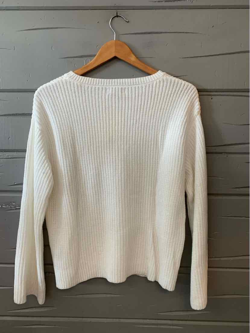 White ribbed knit long-sleeve sweater with a crew neckline on a wooden hanger.