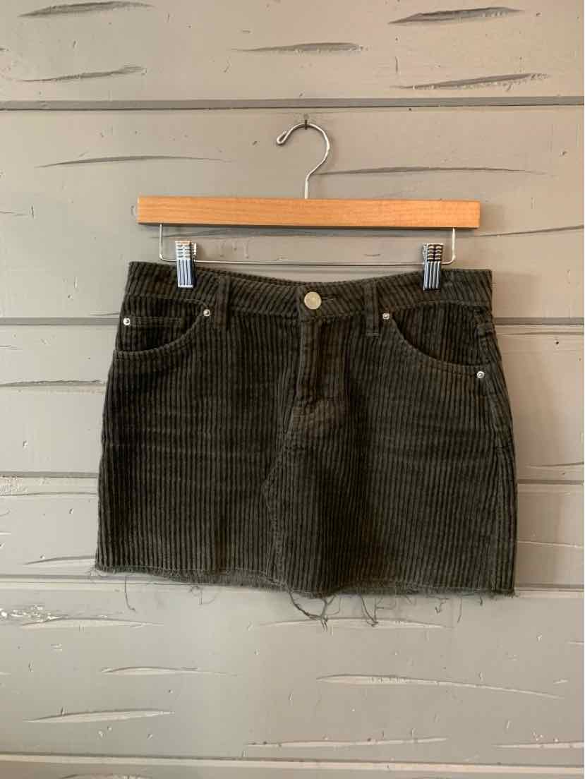 Dark gray corduroy mini skirt with front button and zipper, two front pockets, and frayed hem.