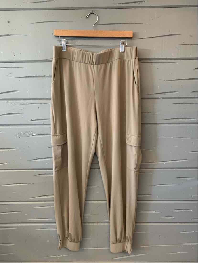 Tan Lisa Rinna pants with an elastic waistband, cargo pockets, and gathered ankle cuffs.