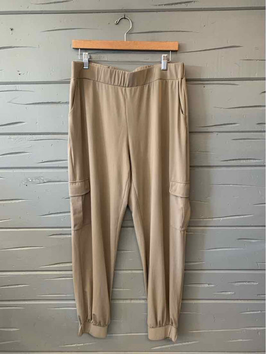 Tan Lisa Rinna pants with an elastic waistband, cargo pockets, and gathered ankle cuffs.
