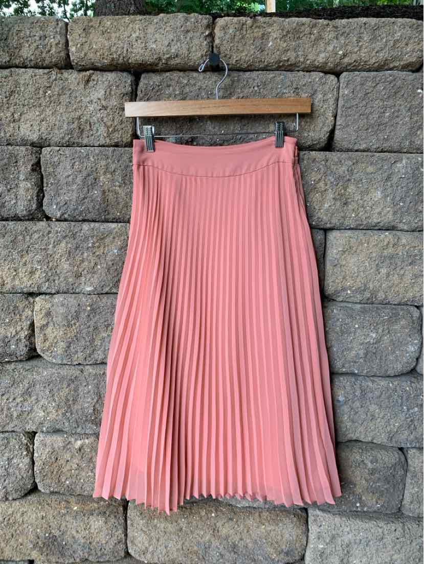 Dusty pink pleated midi skirt with a waistband, lightweight flowy fabric.