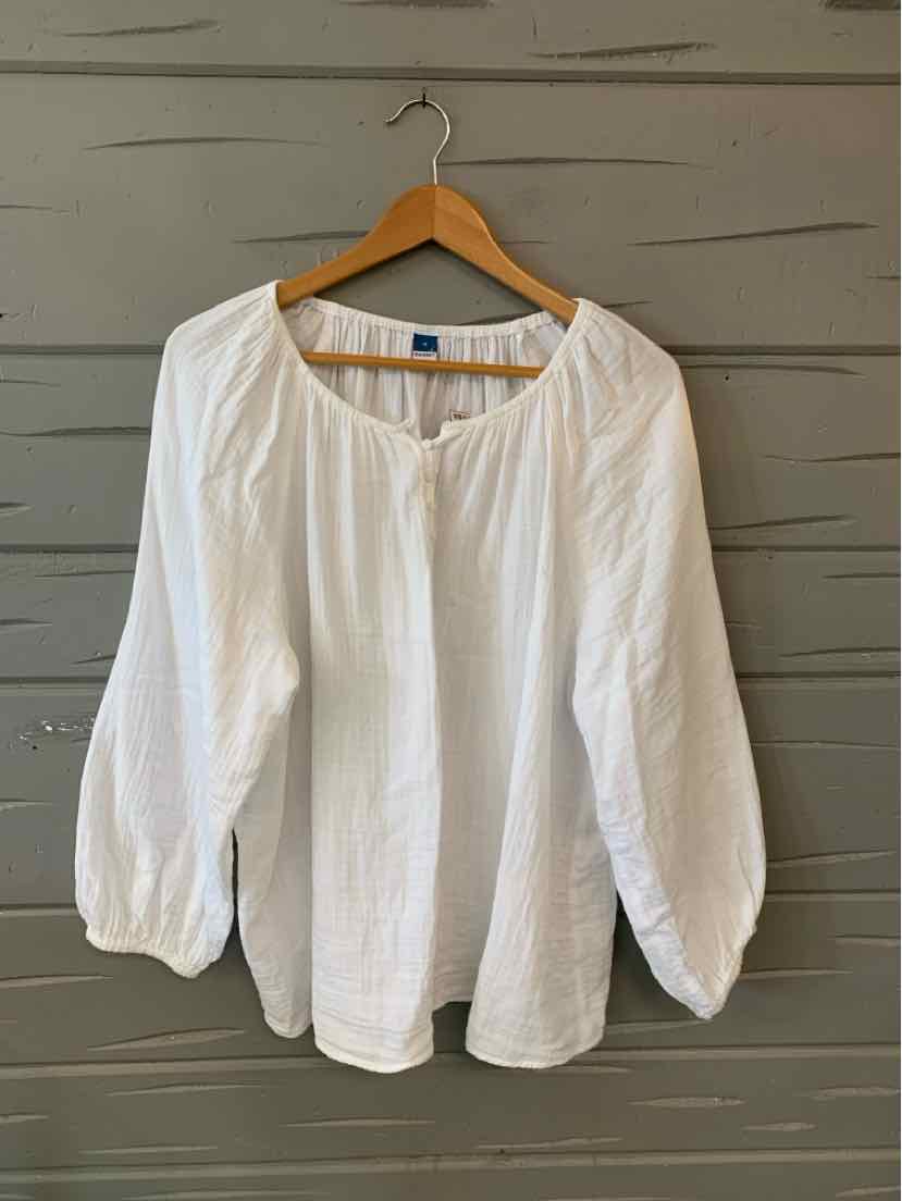 White long-sleeve blouse with gathered neckline and cuffs on wooden hanger.