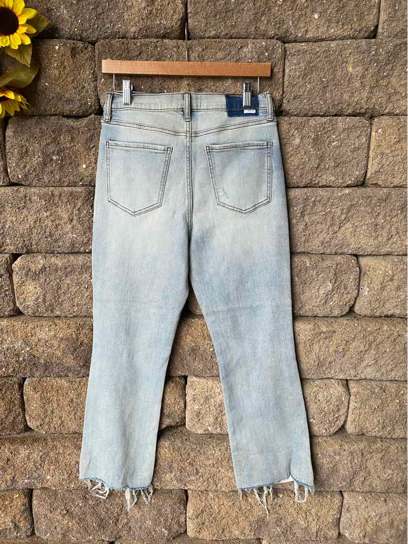 Light wash blue denim jeans with a straight leg cut and raw hem detailing at the ankles.
