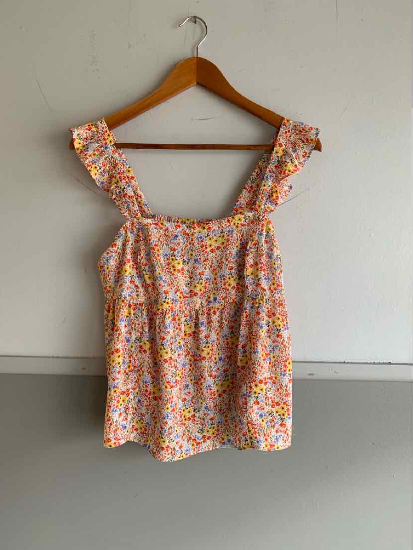 Sleeveless floral top with ruffled straps in orange, pink, and white on a light background.