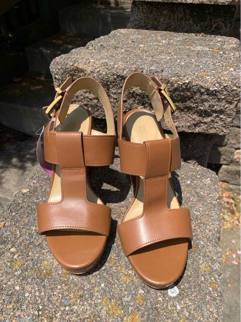 Tan leather open-toe sandals with ankle straps and gold buckle closures, size 6.