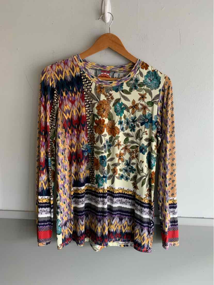 Long-sleeve floral blouse with mixed colorful patterns in blue, orange, purple, and brown on soft fabric.