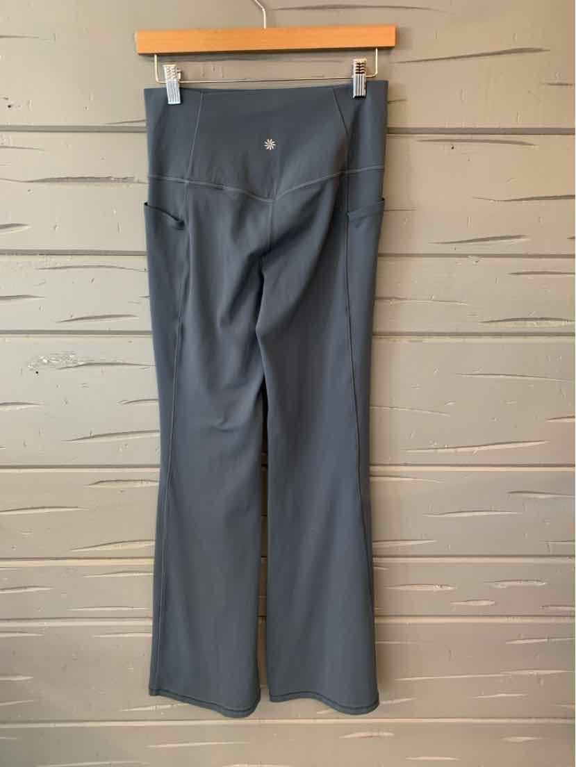 Dark blue high-waisted athletic pants with a flared leg and a small logo near the waistband.
