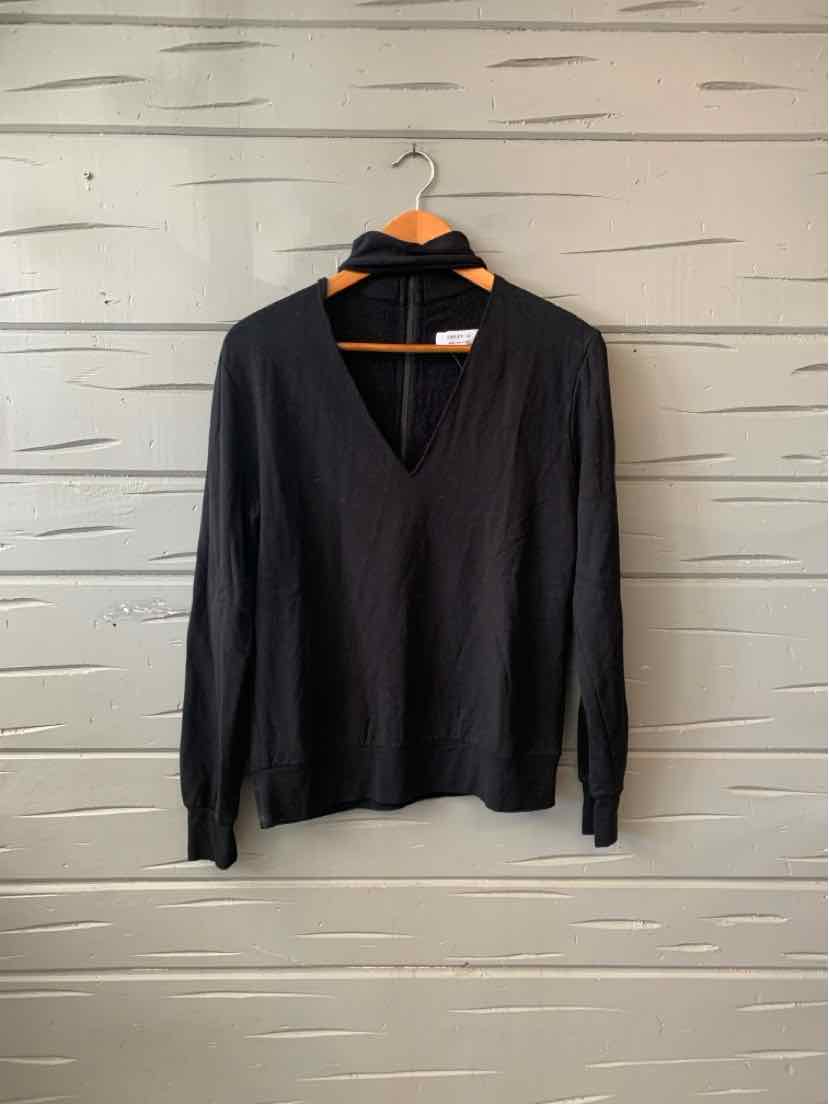 Black long-sleeve V-neck sweater in medium size hanging on wooden hanger.