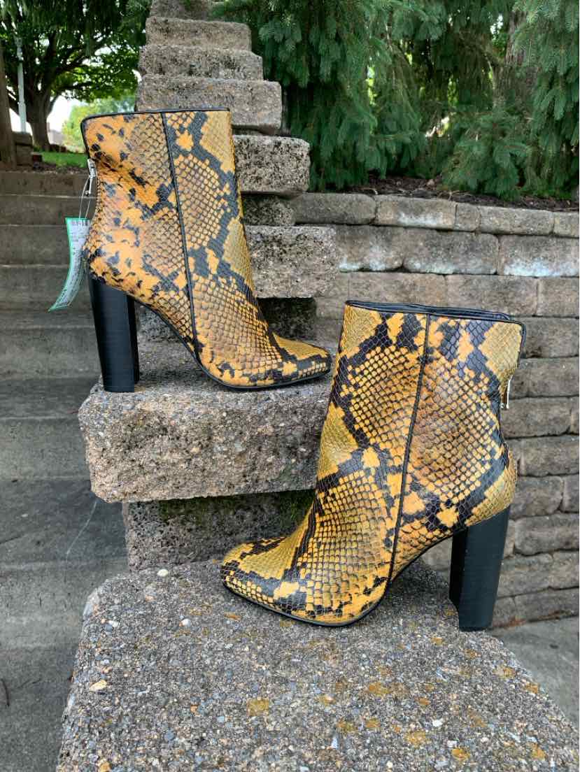 Yellow and black snake print ankle boots with chunky black heels and side zippers.