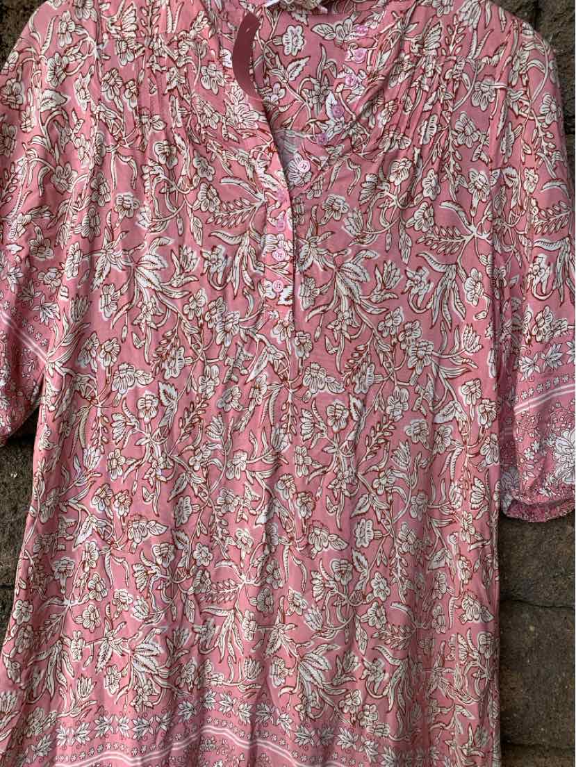 Pink floral print blouse with three-quarter sleeves and a partial button front.