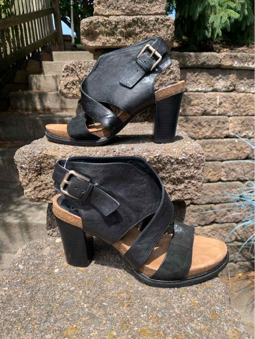 Black leather women's high-heeled sandal with wide straps and gold buckle details, size 9.