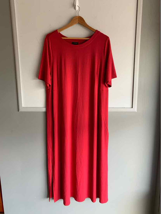 Solid red short-sleeve midi dress with a round neckline hanging on wooden hanger.