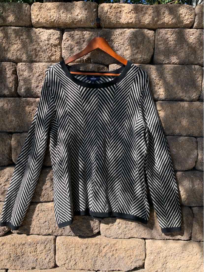 Black and white chevron-patterned long-sleeve sweater with crew neckline, size large.