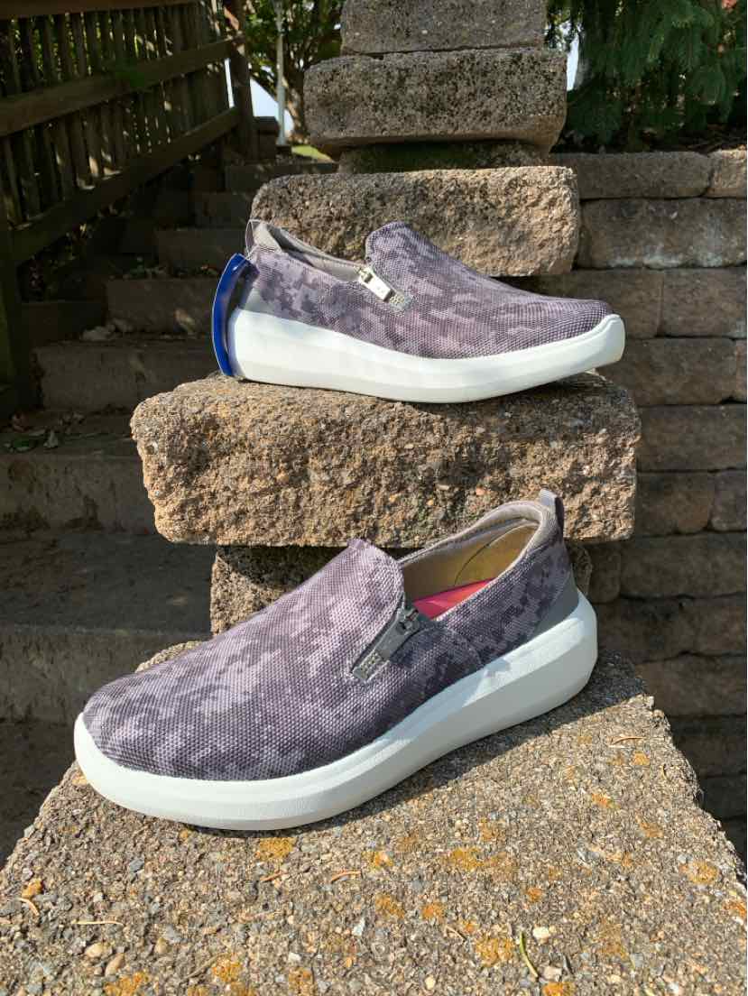 Women’s gray camouflage slip-on sneakers with breathable mesh uppers, white soles, and pink accents.