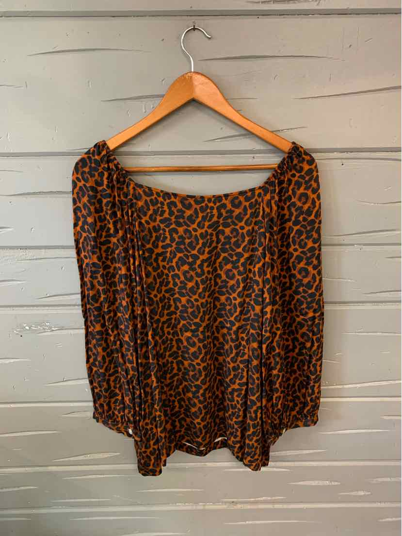 Brown leopard print blouse with long sleeves and elastic neckline on wooden hanger.