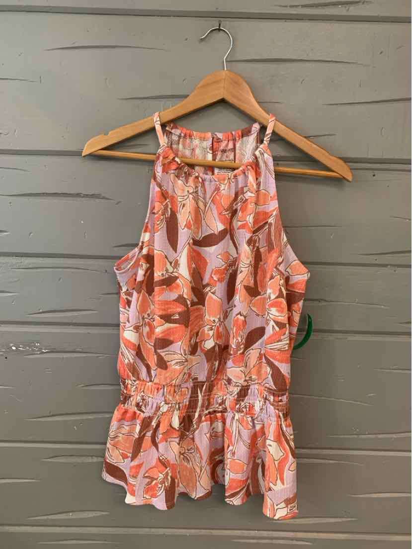 Pink floral sleeveless blouse with ruffled hem and high neckline on wooden hanger.