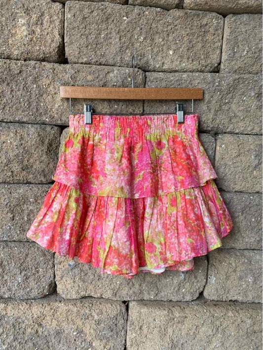Pink floral tiered ruffle mini skirt with elastic waistband and layered hem.